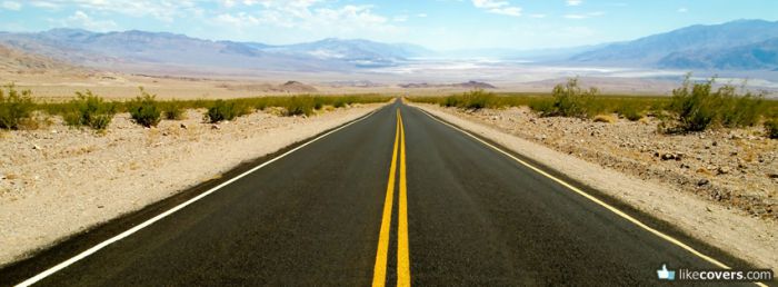 Empty desert road with two yellow lines