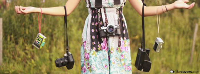 Girl Photographer holding up Vintage Cameras