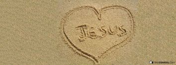 Love Jesus written in the beach sand