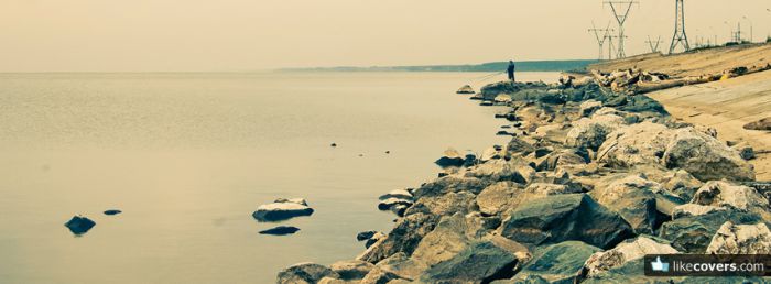 Rocks on a river bay and a guy fishing