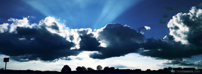 Sunburst in blue sky behind clouds Facebook Covers